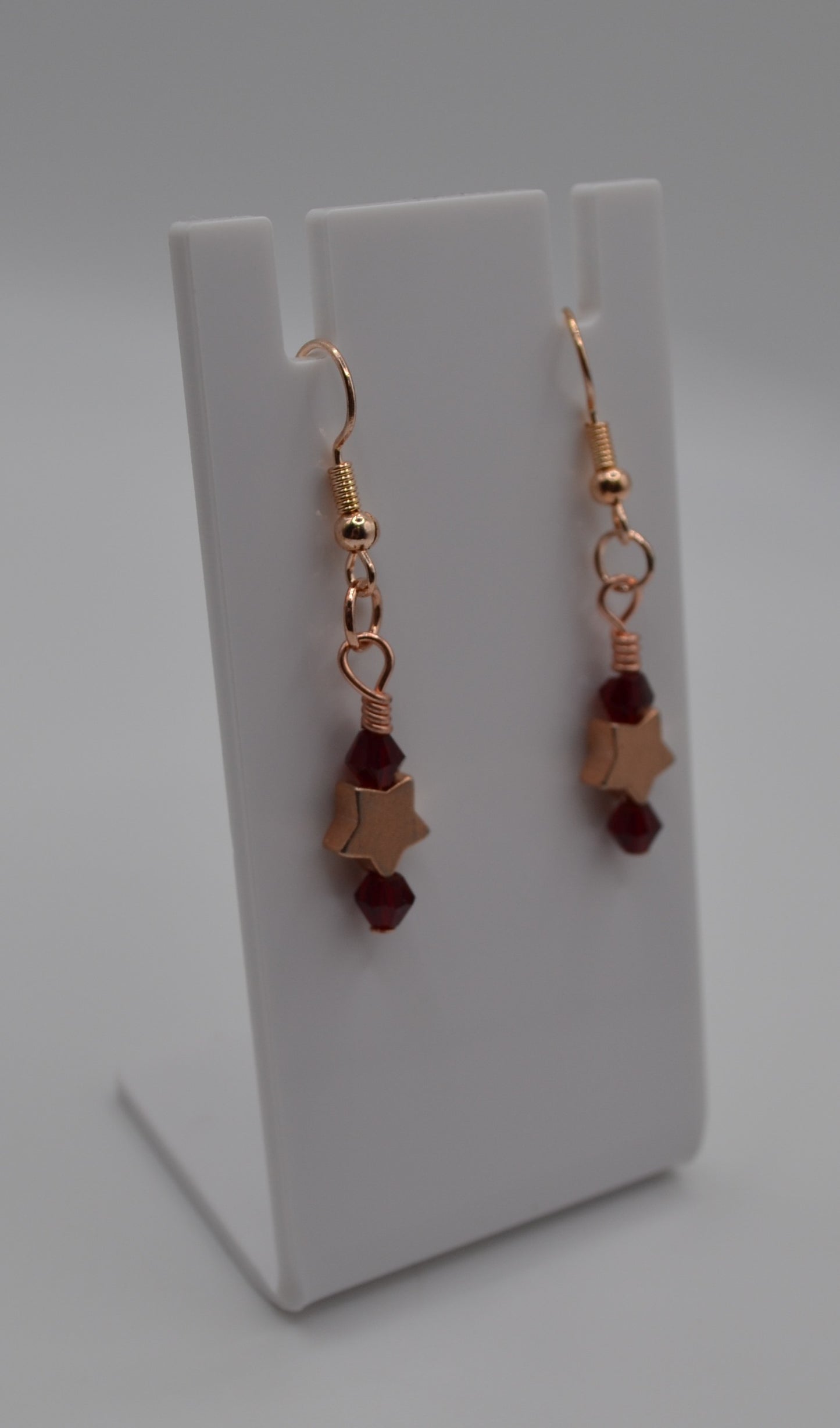 Burgundy rose gold star earrings